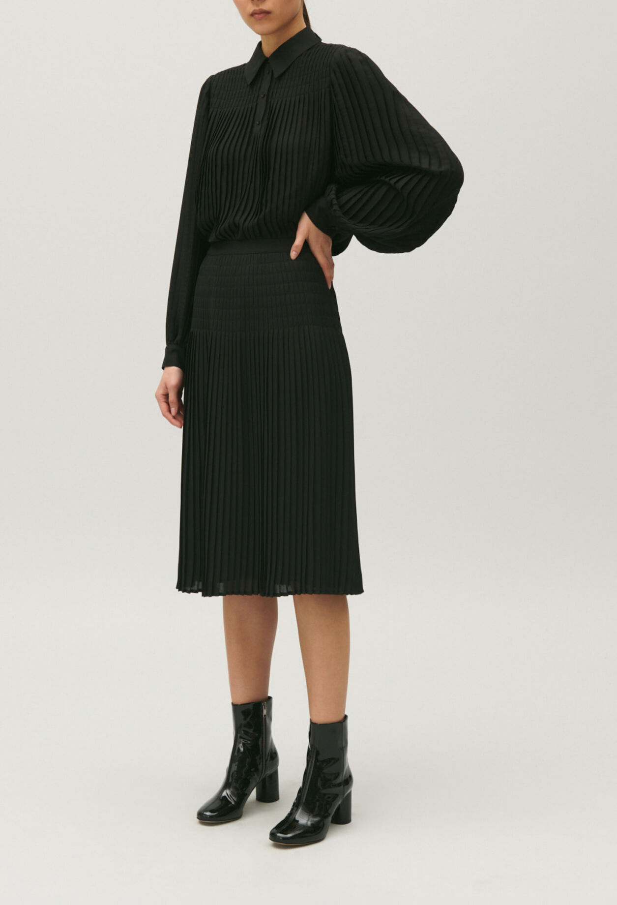 Black pleated mid-length skirt